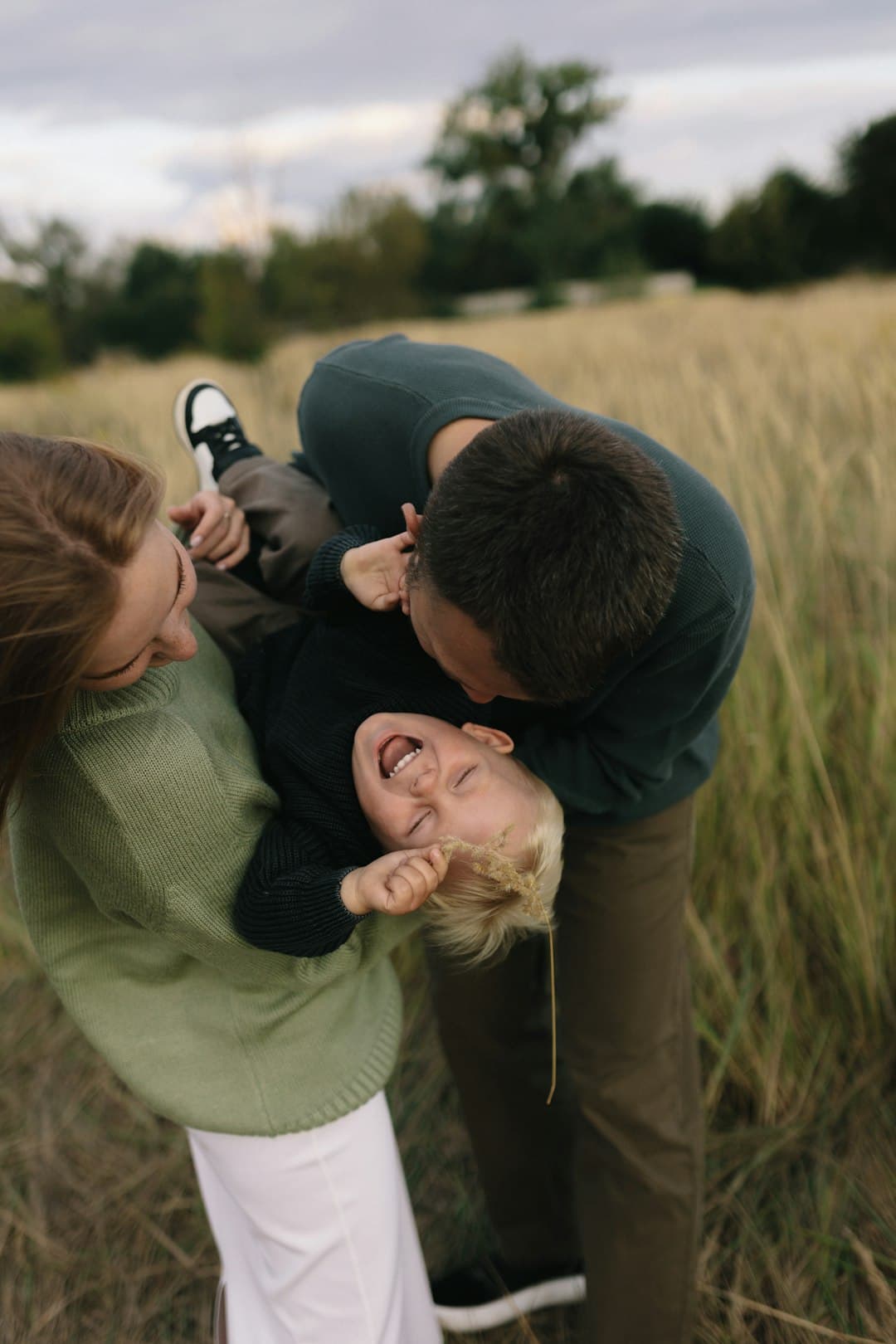 A family smiling together outdoors