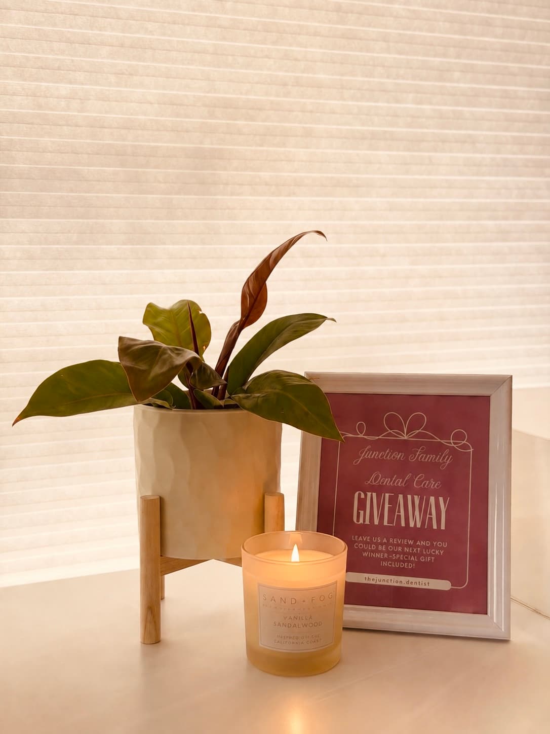 Giveaway sign with plant and candle in the clinic