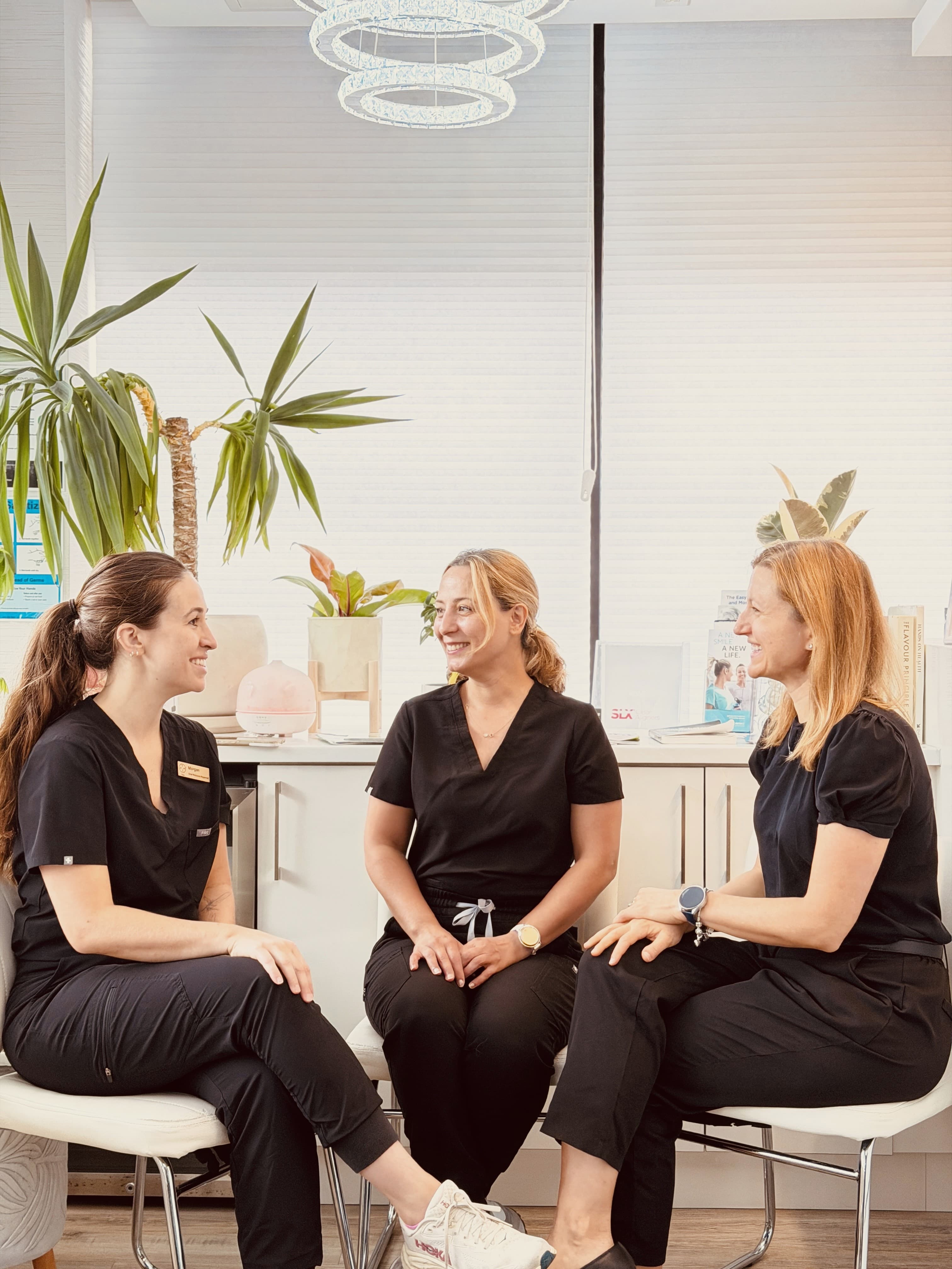 Three dental professionals chatting together